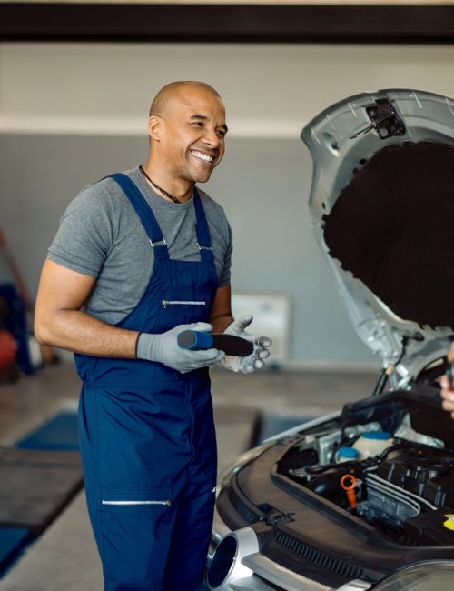 happy-african-american-auto-repairman-talking-customer-workshop-scaled.jpg