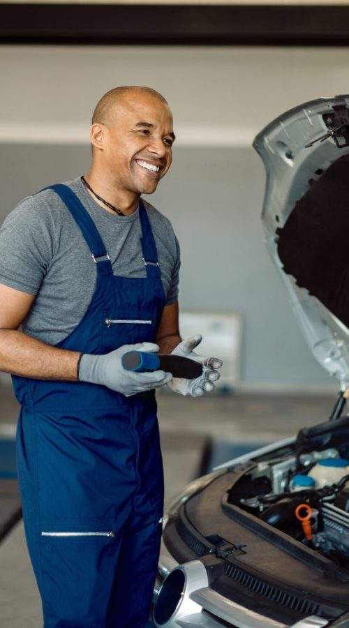 happy-african-american-auto-repairman-talking-customer-workshop-scaled.jpg